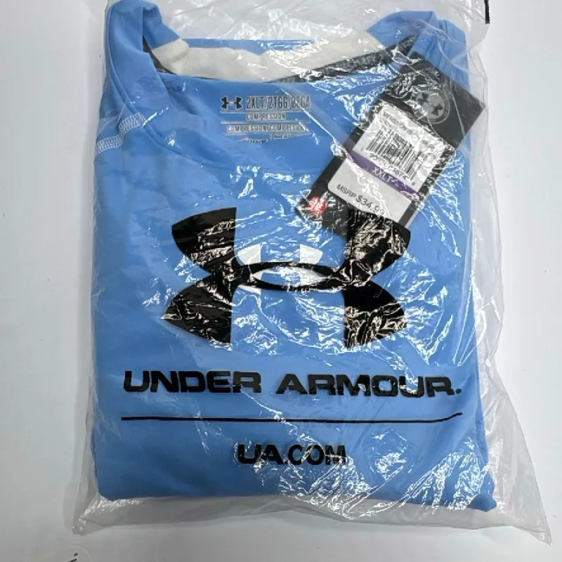 An Under Armour compression shirt still sealed in its poly bag with the retail tag attached.